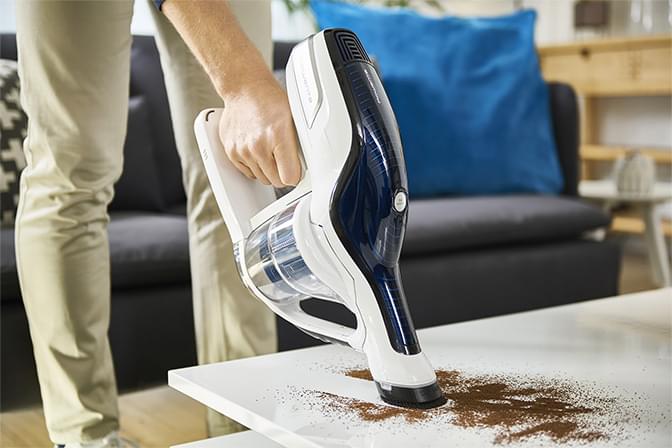 Man vacuuming on a table
